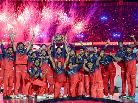 Royal Challengers Bengaluru's players celebrate with the trophy after winning the Indian Premier League 2025 crown beating Punjab Kings in the finals.