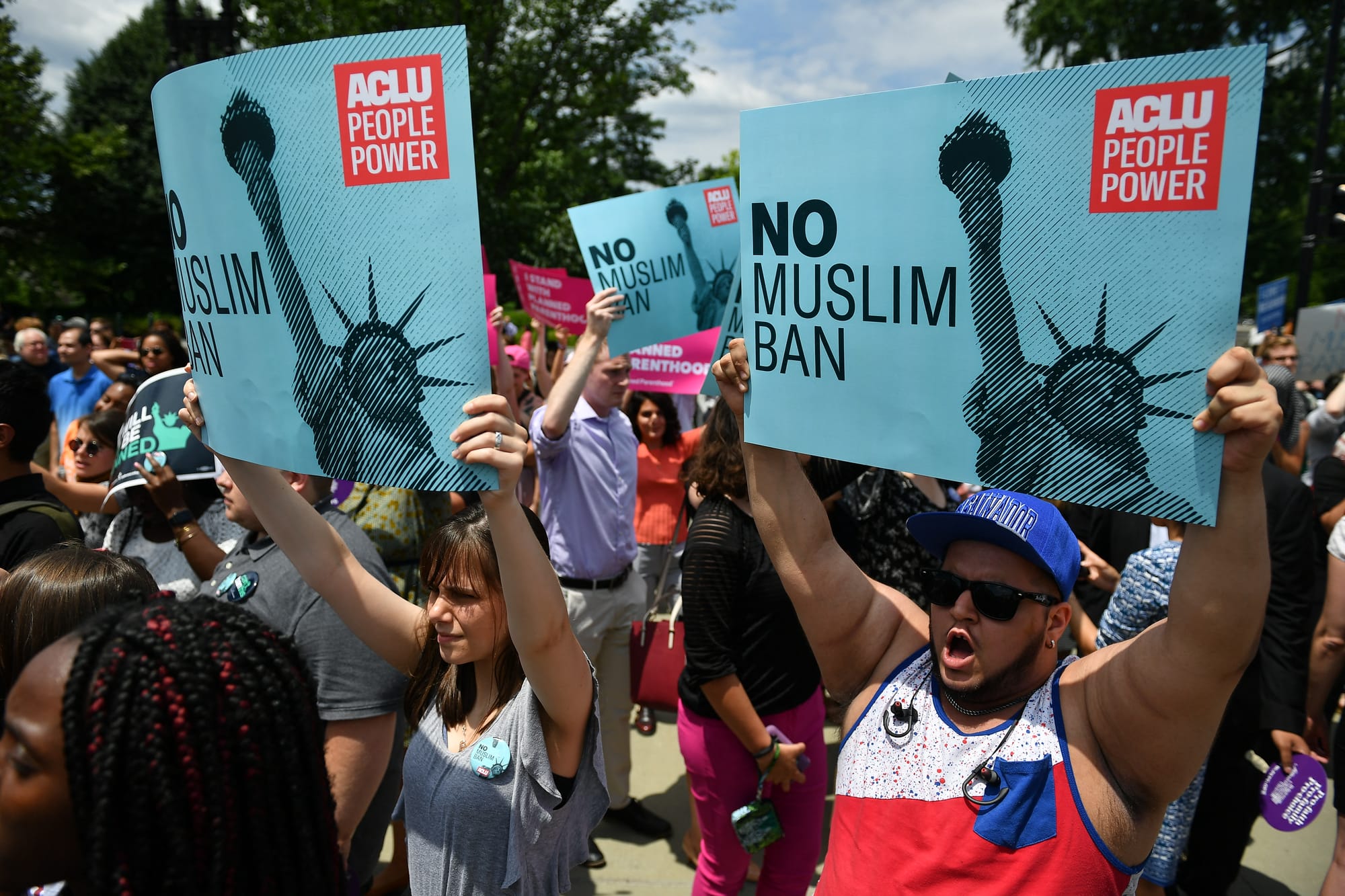 People protest the Muslim travel ban in front of the US Supreme Court in Washington, DC on June 26, 2018.