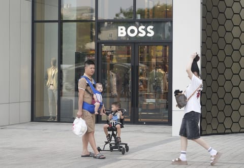 A family shopping at a shopping mall in Hanoi, Vietnam, Wednesday, June 4, 2025.  