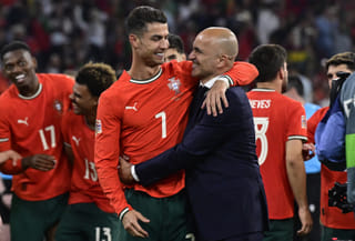 Portugal's forward #07 Cristiano Ronaldo and Portugal's Spanish head coach Roberto Martinez celebrate winning the UEFA Nations League final football match between Portugal and Spain in Munich, southern Germany on June 8, 2025.