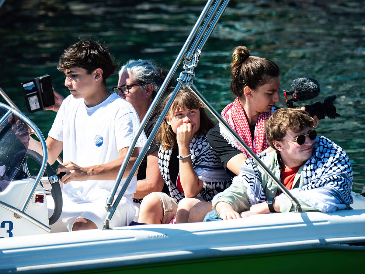 Climate activist Greta Thunberg, center, waits to board the Madleen boat, before setting sail for Gaza along with activists of the Freedom Flotilla Coalition, departing from the Sicilian port of Catania, Italy, Sunday, June 1, 2025. 