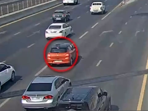 Oblivious to the accident he has caused, the driver can be seen continuing on his way.