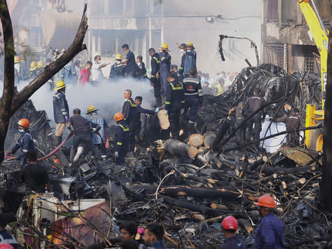 Search and rescue teams respond to the scene of a plane crash in Ahmedabad, India, on Thursday, June 12, 2025. 