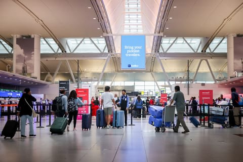 Travelers in Terminal 4 of John F. Kennedy International Airport (JFK) in New York.