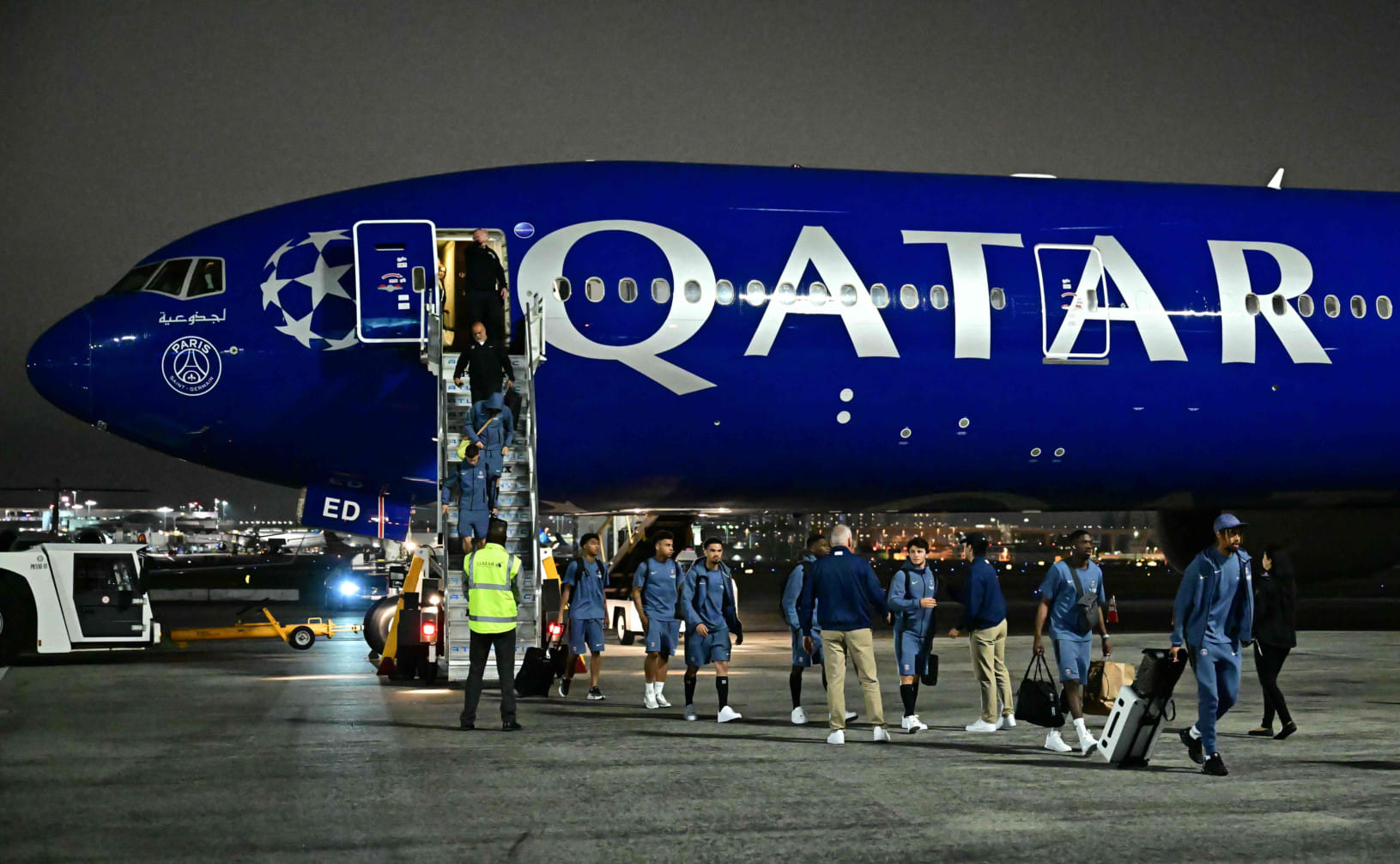 FC Paris Saint-Germain (PSG) players walk on the tarmac after landing at Los Angeles International Airport (LAX) on June 10.