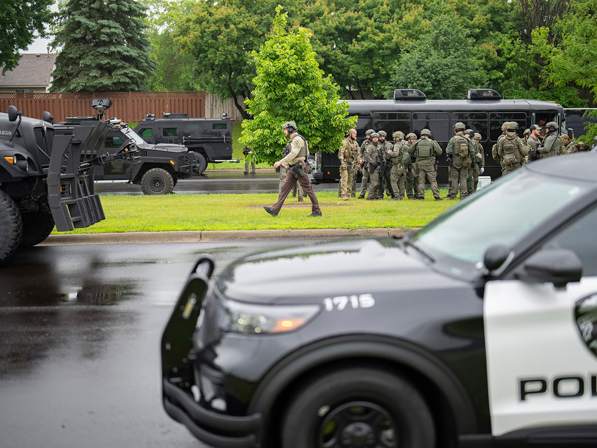 Law enforcement officers including local police, sheriffs and the FBI, stage less than a mile from a shooting in Brooklyn Park, Minnesota on Saturday, June 14, 2025. 
