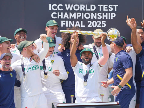 South Africa's captain Temba Bavuma holds the winner's trophy and celebrates with teammates on the podium after their win in the World Test Championship against Australia at Lord's cricket ground in London, on Saturday, June 14, 2025. 