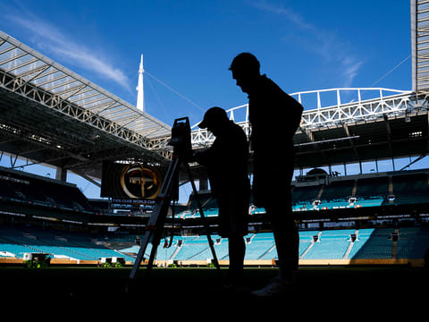 Workers get the pitch ready at the Hard Rock Stadium in Miami Gardens, Florida on June 13, 2025, on the eve of the Club World Cup 2025 Group A football match between Egypt's Al-Ahly and US Inter Miami. 
