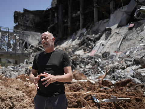 Professor Ori Ozeri speaks in front of damage to the Weizmann Institute of Science from an Iranian missile strike in Rehovot, Thursday, June 19, 2025. 