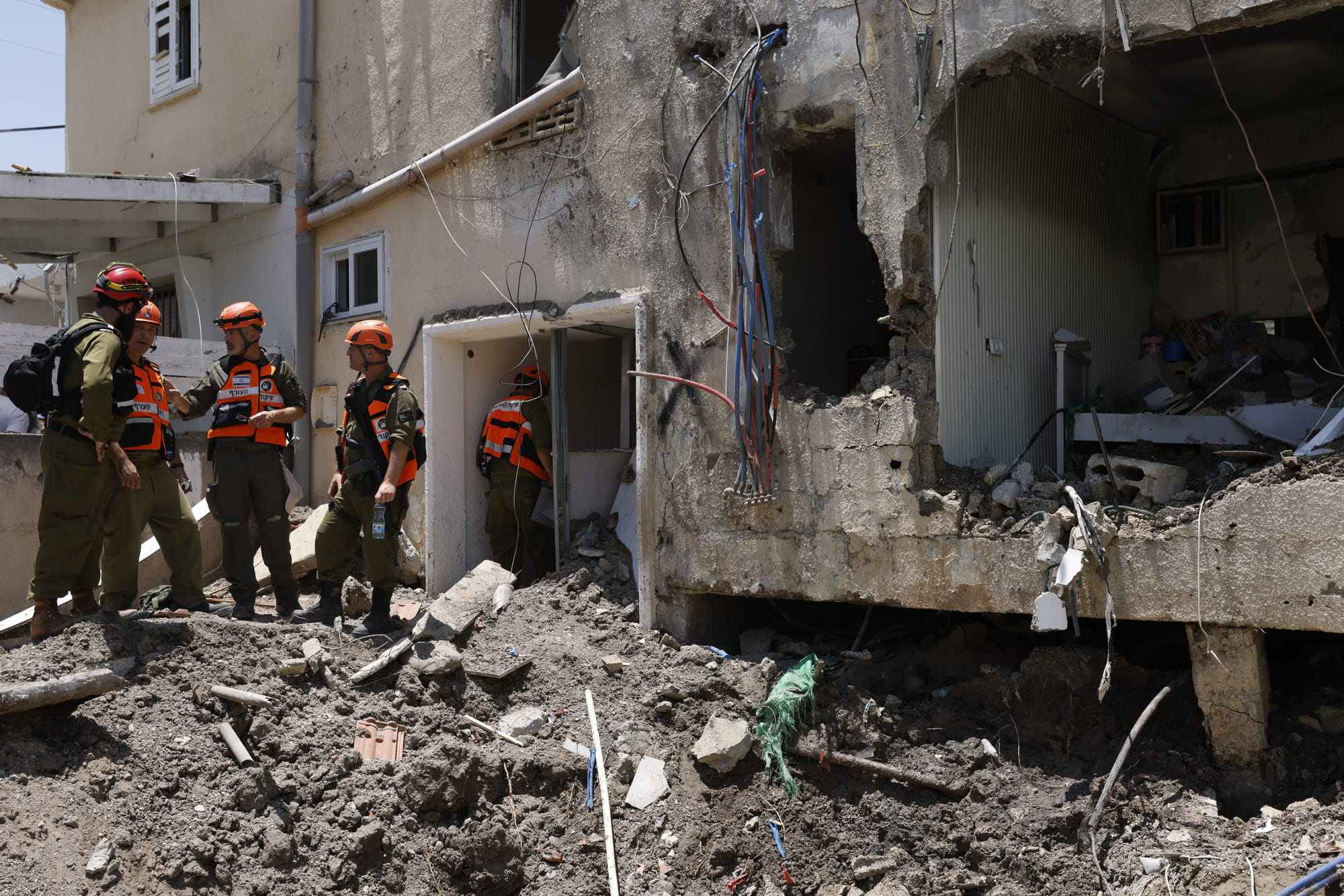 Israeli soldiers and first responders check the damage caused to a building from an Iranian strike in Beit She'an on June 21, 2025, amid the ongoing fire exchange between Iran and Israel.