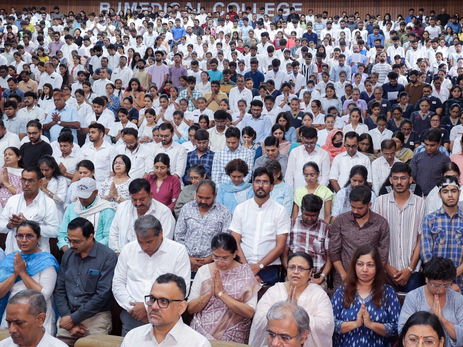 Families of the deceased, the injured, students, and teachers during the prayer gathering at BJ Medical College.
