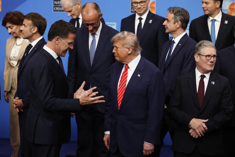 President Donald Trump, center, speaks with NATO Secretary General Mark Rutte, left, during a group photo of NATO heads of state and government at the NATO summit in The Hague, Netherlands, Wednesday, June 25, 2025.