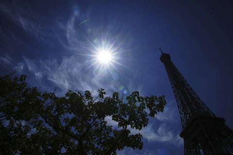 The sun shines over the the Eiffel Tower during a heat wave, Monday, June 30, 2025 in Paris. 