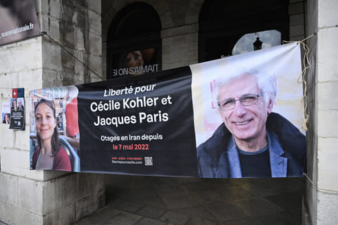 This photograph shows a banner depicting French Cecile Kholer and Jacques Paris detained in Iran for almost three years, during a rally for their release, in front of Bayonne town hall, southwestern France,on May 07,2025.