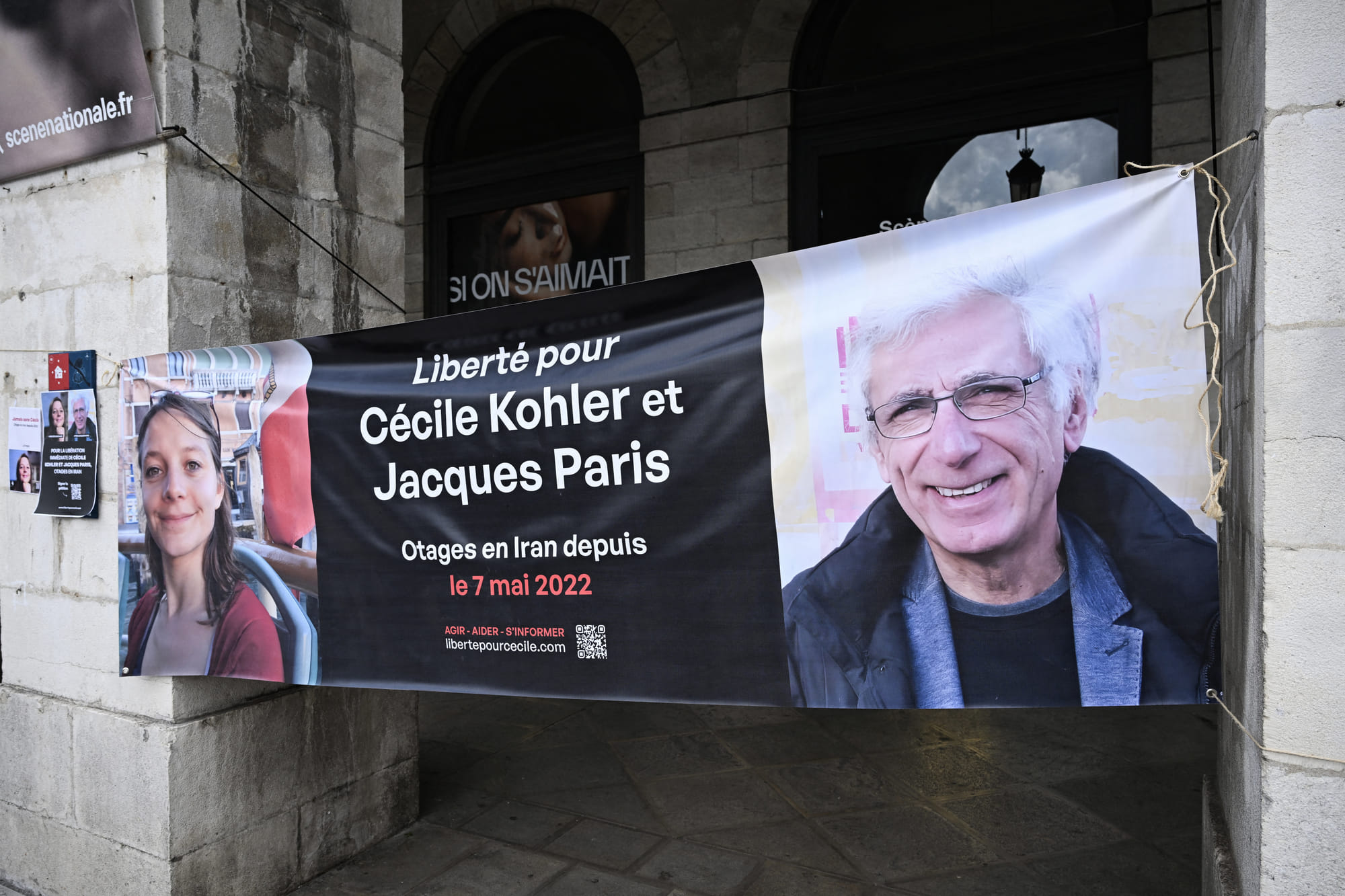 This photograph shows a banner depicting French Cecile Kholer and Jacques Paris detained in Iran for almost three years, during a rally for their release, in front of Bayonne town hall, southwestern France,on May 07,2025.