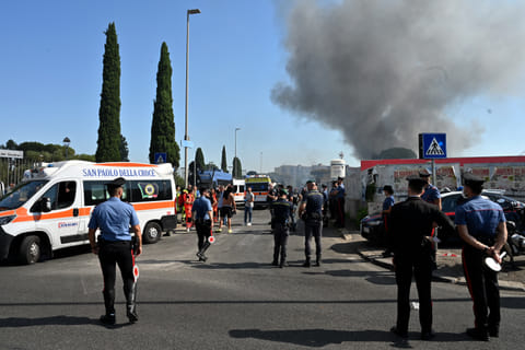 Firemen, policemen and rescue teams work on the site of an explosion in a fuel station in Rome on July 4, 2025.
