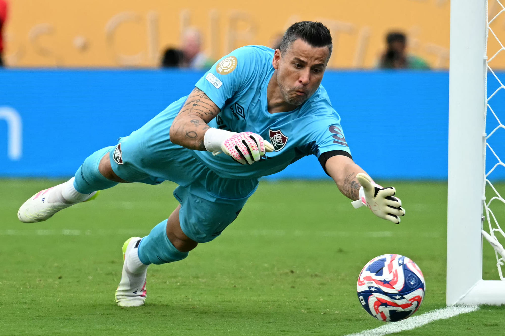 Fluminense's Brazilian goalkeeper Fabio dives to stop a ball during the Fifa Club World Cup 2025 quarter-final football match against Saudi Arabia's Al Hilal at the Camping World Stadium in Orlando on July 4, 2025.