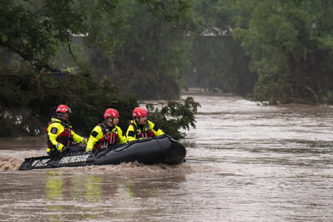 Boerne Search and Rescue teams navigate upstream in an inflatable boat on the flooded Guadalupe River on July 4, 2025 in Comfort, Texas.