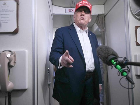US President Donald Trump speaks to journalists aboard Air Force One after departing Joint Base Andrews, Maryland on his way to Bedminster, New Jersey on July 4, 2025. A