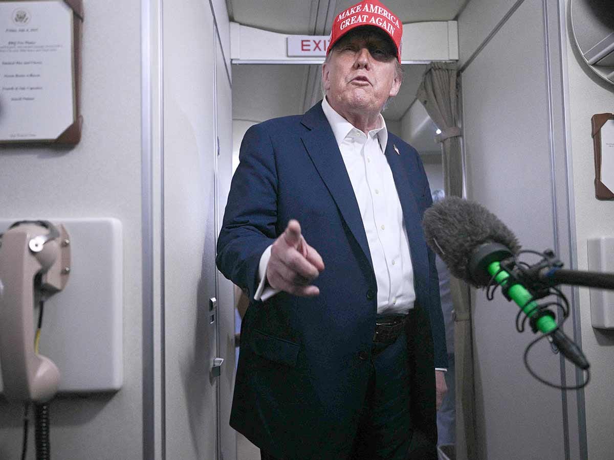 US President Donald Trump speaks to journalists aboard Air Force One after departing Joint Base Andrews, Maryland on his way to Bedminster, New Jersey on July 4, 2025. A