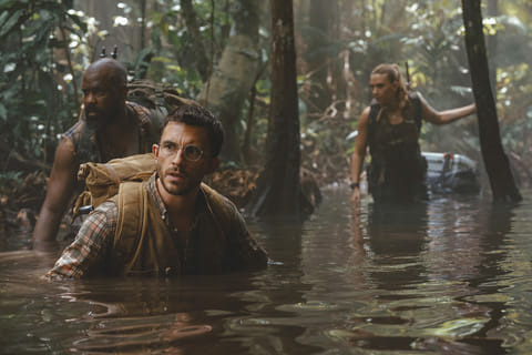 From left: Bechir Sylvain, Jonathan Bailey, and Scarlett Johansson in a scene from " Jurassic World: Rebirth." 