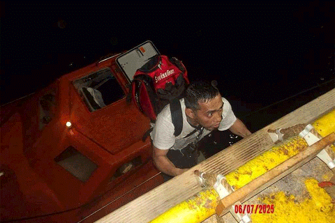 This handout picture provided by the UAE Ministry of Foreign Affairs reportedly shows members of the Greek owned, Liberian-flagged Magic Seas commercial vessel climbing on board the Safeen Prism, after being rescued following an attack that forced them to abandon ship, in the Red Sea on July 6, 2025.  In a statement, the Ministry of Foreign Affairs (MoFA) confirmed that the UAE's response operation successfully rescued all 22 individuals aboard the vessel, including crew and security personnel.