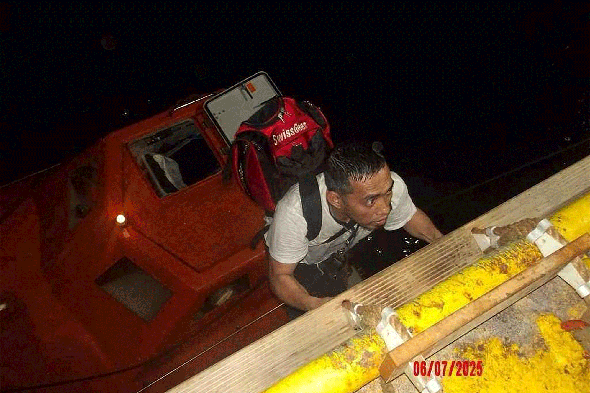 This handout picture provided by the UAE Ministry of Foreign Affairs reportedly shows members of the Greek owned, Liberian-flagged Magic Seas commercial vessel climbing on board the Safeen Prism, after being rescued following an attack that forced them to abandon ship, in the Red Sea on July 6, 2025.  In a statement, the Ministry of Foreign Affairs (MoFA) confirmed that the UAE's response operation successfully rescued all 22 individuals aboard the vessel, including crew and security personnel.
