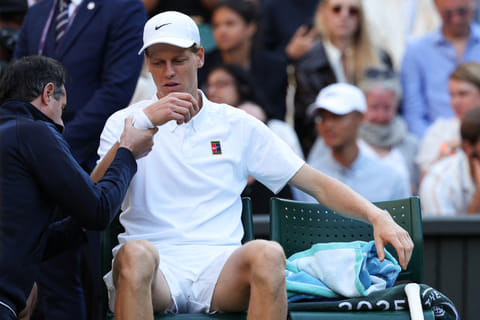 Italy's Jannik Sinner reacts as he receives medical treatment during his men's singles fourth round tennis match against Bulgaria's Grigor Dimitrov on the eighth day of the 2025 Wimbledon Championships at The All England Lawn Tennis and Croquet Club in Wimbledon, southwest London, on July 7, 2025.