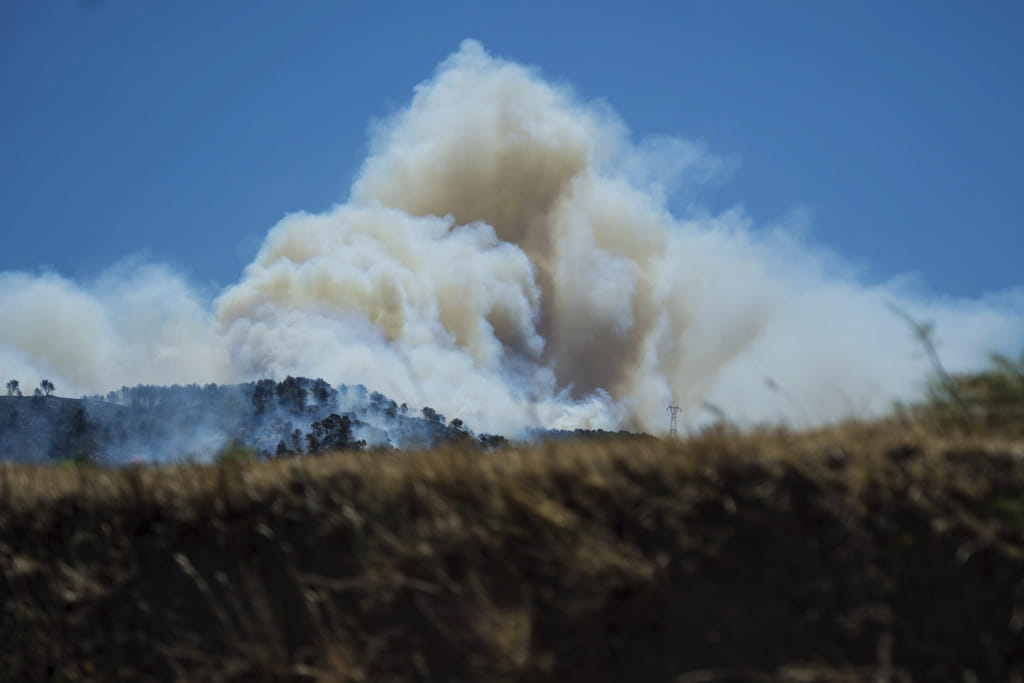 This photo provided by the fire brigade Pompiers13, shows a cloud of smoke over hills near Marseille, southern France, Tuesday, July 8, 2025. 
