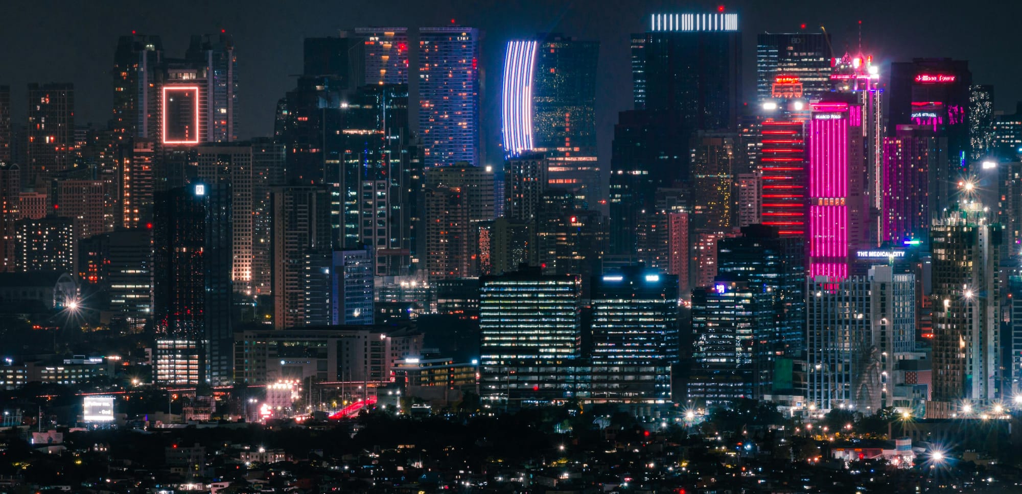 A night-time view of Manila skyscrapers. Despite a rise from $4,320 in 2023 to $4,470 in 2024 in gross national income (GNI) per capita, the Philippines was $26 short of the minimum upper middle income status threshold of $4,496. 