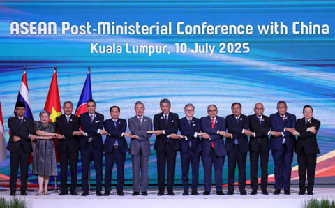 Indonesia's Minister for Foreign Affairs Sugiono, Philippines' Secretary of Foreign Affairs Theresa Lazaro, Singapore's Minister for Foreign Affairs Vivian Balakrishnan, Thailand's Minister of Foreign Affairs Maris Sangiampongsa, Vietnam's Minister of Foreign Affairs Bui Thanh Son, China's Foreign Minister Wang Yi, Malaysia's Minister of Foreign Affairs Mohamad Hasan, Laos' Minister of Foreign Affairs Thongsavanh Phomvihane, Brunei's Second Minister of Foreign Affairs Erywan Yusof, Cambodia's Minister of Foreign Affairs Prak Sokhonn, Myanmar's Acting Permanent Secretary of the Ministry of Foreign Affairs Kyaw Nyun Oo, Timor-Leste's Minister of Foreign Affairs Bendito dos Santos Freitas and Secretary General of the ASEAN Kao Kim Hourn pose for a group photo as they attend the Association of Southeast Asian Nations (ASEAN) Post-Ministerial Conference with China during the 58th ASEAN Foreign Ministers’ meeting and related meetings at the Convention Centre in Kuala Lumpur on July 10, 2025.