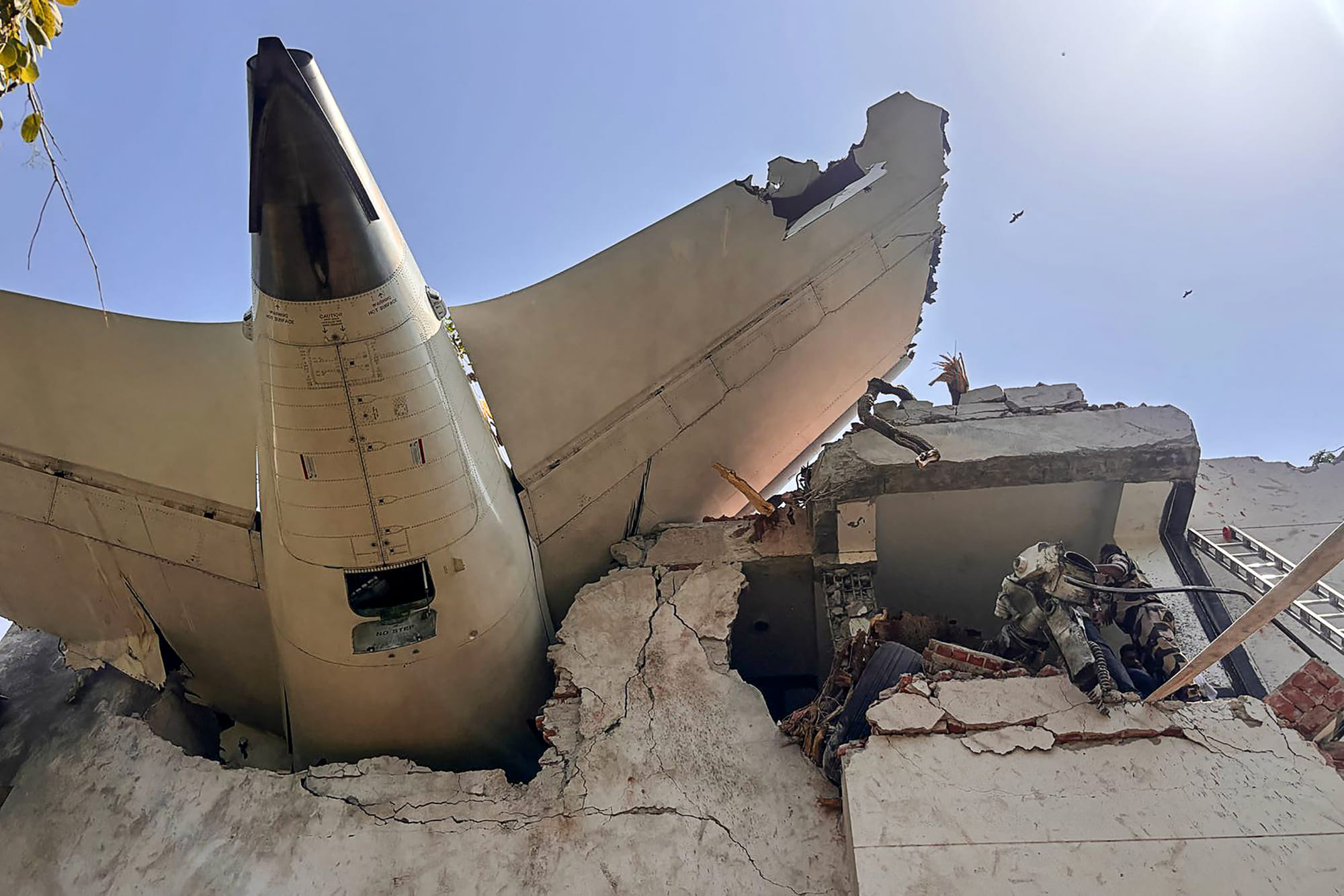 This handout photograph taken and posted on the X (formerly Twitter) account of the Central Industrial Security Force (CISF) on June 12, 2025 shows the tailpiece of Air India flight AI171 after it crashed in a residential area near the airport in Ahmedabad.