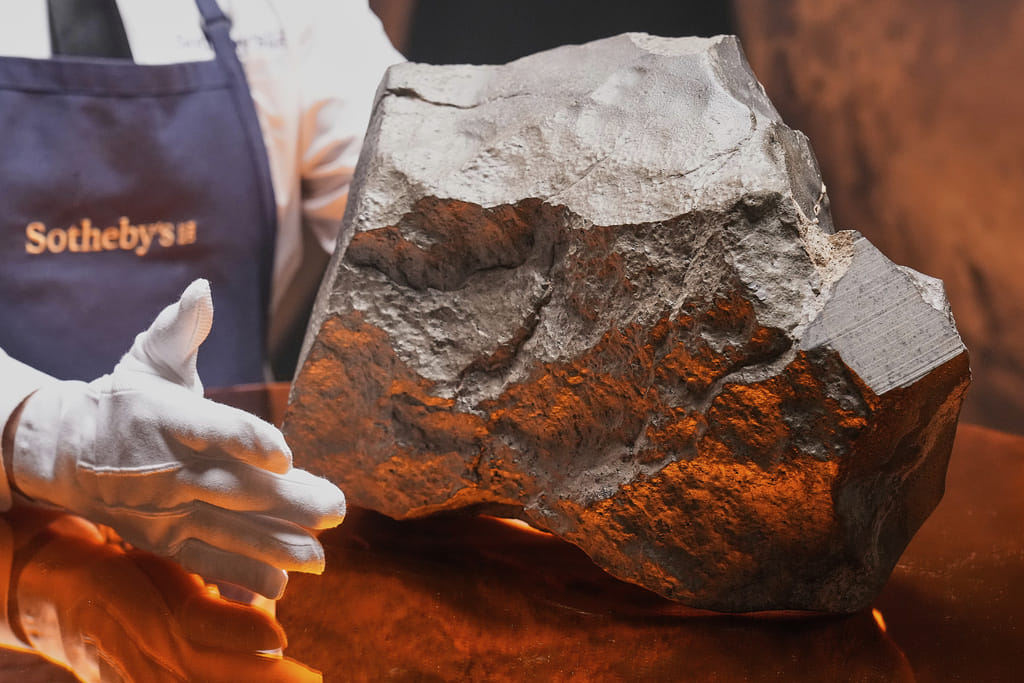 A Martian meteorite, weighing 54.388 lbs. (24.67 kg), said to be the largest piece of Mars on Earth, estimated at $2 - 4 million, is displayed at Sotheby's, 