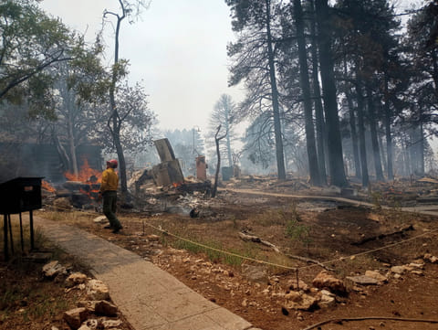 This photo provided by National Park Service shows the charred remains of a building at the North Rim of Grand Canyon National Park, in northern Arizona, on Sunday, July 13, 2025.