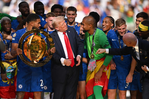 Reece James of Chelsea FC holds the Fifa Club World Cup trophy after their team's victory as American President Donald Trump interacts with Robert Sanchez  during the presentation ceremony on Sunday.