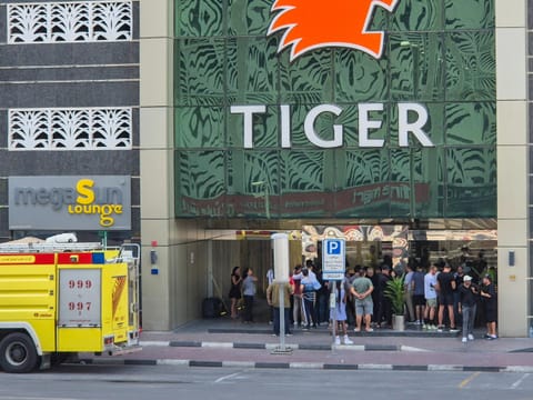 Residents gather outside the 67-storey Marina Pinnacle Tower in Dubai Marina.