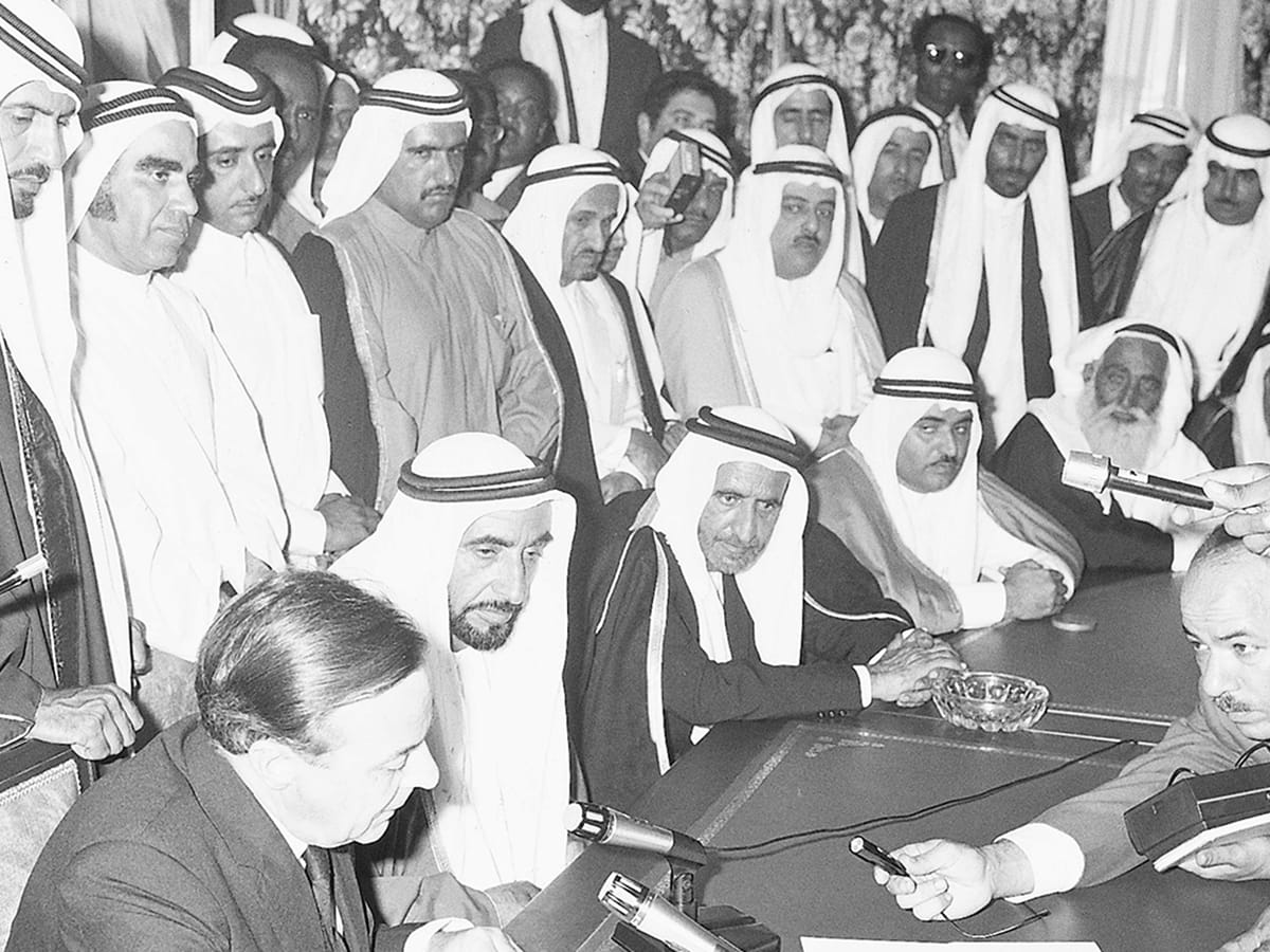 Shaikh Zayed Bin Sultan Al Nahyan - in the presence of Shaikh Rashid Bin Saeed Al Maktoum, the then Ruler of Dubai, Shaikh Khalid Bin Mohammad Al Qasimi, the then Ruler of Sharjah, Shaikh Rashid Bin Humaid Al Nuaimi, the then Ruler of Ajman, Shaikh Mohammad Bin Ahmad Al Sharqi, the then Ruler of Fujairah, and other dignitaries and officials - listens to British diplomat Sir Geoffrey Arthur as he reads out the contents of the document during the proclamation of the Union and the declaration of independence in 1971. - WAM