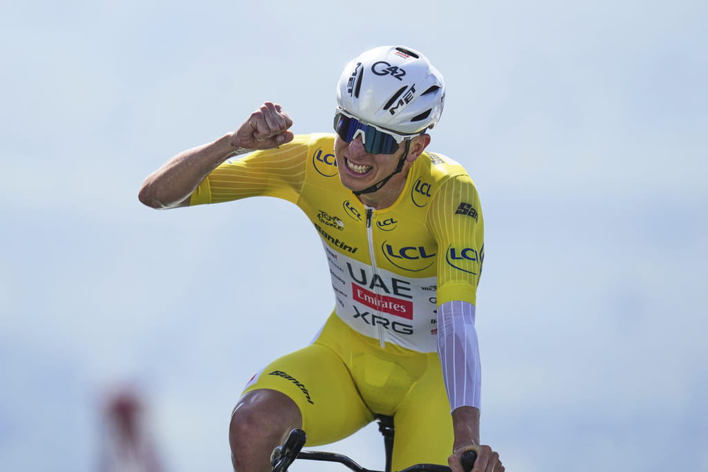 Slovenia's Tadej Pogacar, wearing the overall leader's yellow jersey, celebrates after winning the 13th stage of the Tour de France, an individual time-trial over 10.5 kilometres (6.5 miles) in the Pyrenees mountains on Friday.