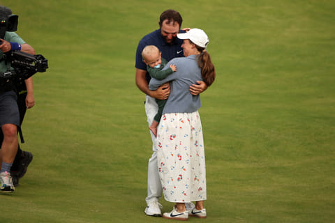 US golfer Scottie Scheffler celebrates with his wife Meredith and son Bennett on the 18th green after his victory in the 153rd Open Championship at Royal Portrush golf club in Northern Ireland on July 20, 2025.