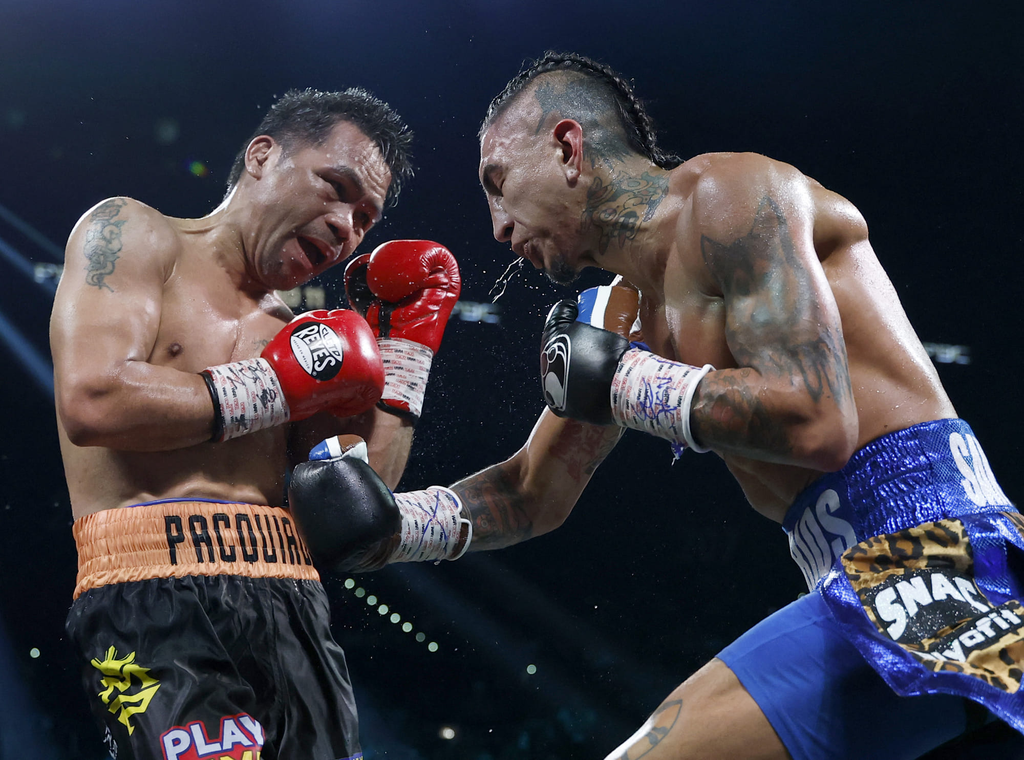 Mario Barrios (R) punches Manny Pacquiao during their WBC welterweight title fight ending in a majority draw at MGM Grand Garden Arena in Las Vegas, Nevada.
