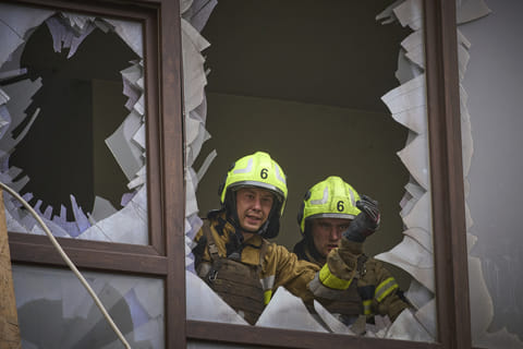 Firefighters work in a destroyed apartment building after a Russian attack in Kyiv, Ukraine, Monday, July 21, 2025. 