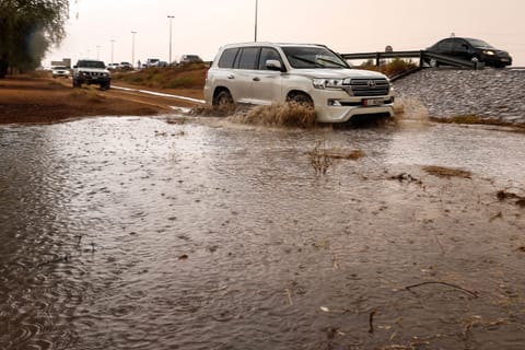 People drive their cars off-road through mud puddles amid heavy rainfall on the outskirts of Dubai. Rainfall reaches the outskirts of Al Ain and Dubai — from Margham to Al Lisailli — bringing a rare and refreshing change to the skies.