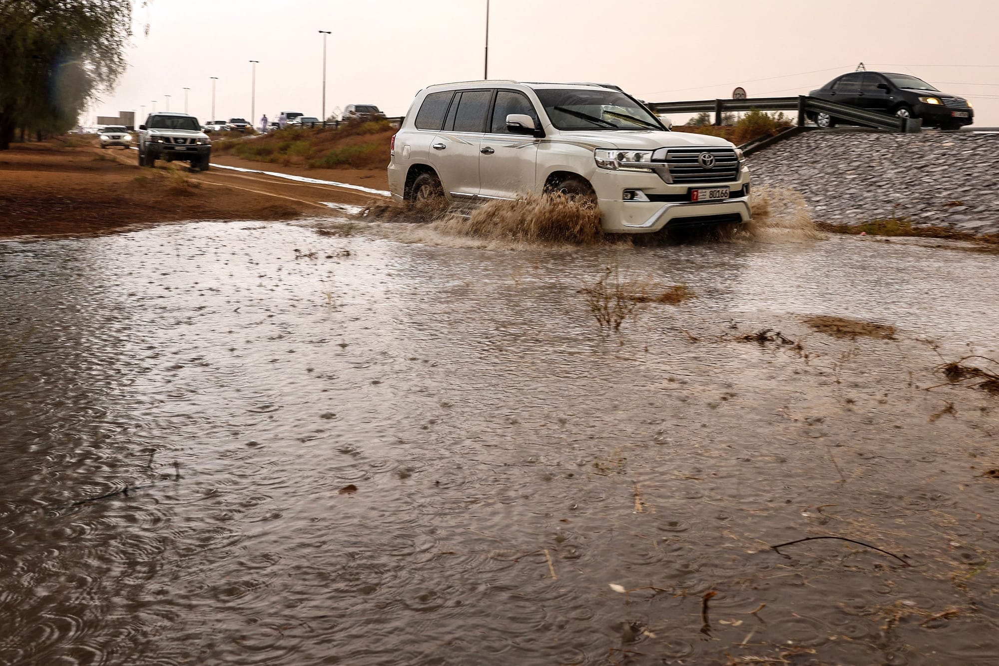 People drive their cars off-road through mud puddles amid heavy rainfall on the outskirts of Dubai. Rainfall reaches the outskirts of Al Ain and Dubai — from Margham to Al Lisailli — bringing a rare and refreshing change to the skies.