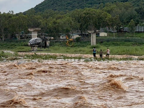 Clinging to a small patch of land surrounded by powerful currents, the boy and the animal faced imminent danger.