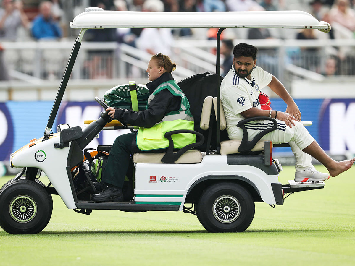 India's Rishabh Pant reacts as he driven on a buggy out of the pitch following a foot injury while playing on day one of the fourth Test against England at Old Trafford, in Manchester, north England, on July 23, 2025.