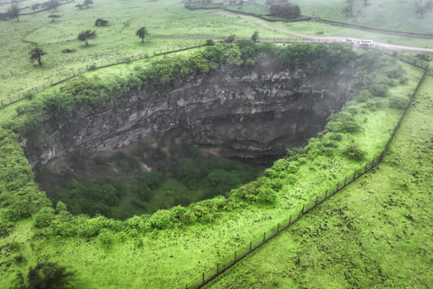 An aerial picture shows a view of the Sheeheet sinkhole in Oman's Dhofar region near the city of Taqah on July 25, 2025.