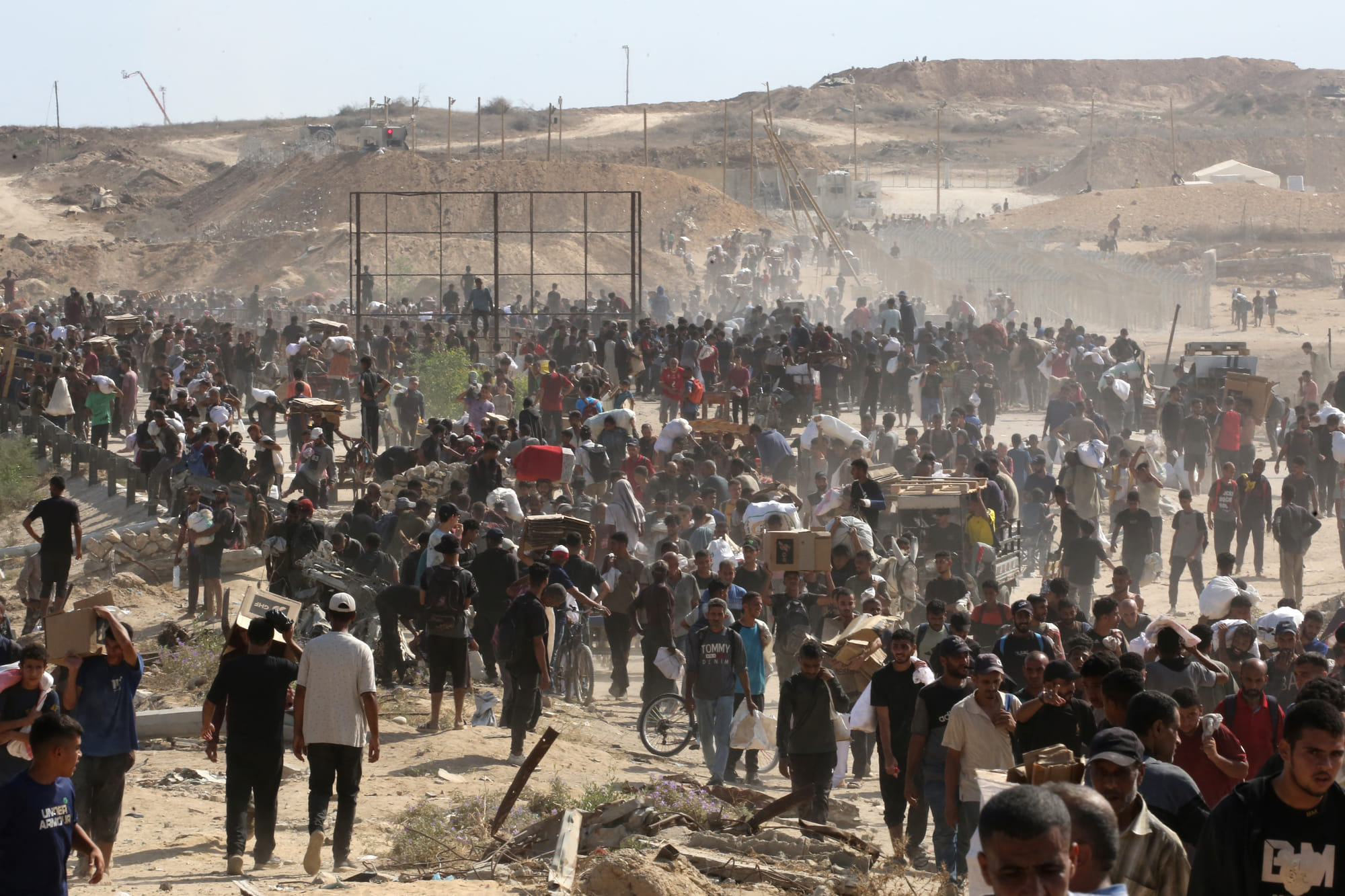 Displaced Palestinians gather to receive aid from a GHF aid distribution point at the so-called "Netzarim corridor" in the central Gaza Strip on July 30, 2025.