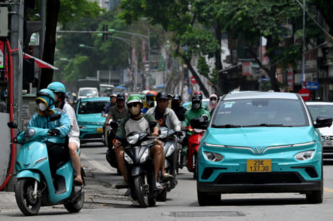 Vinfast electric vehicles are pictured on a street in Hanoi on July 31, 2025.