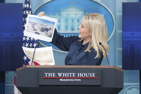 White House press secretary Karoline Leavitt holds up photos of the planned new White House ballroom during a press briefing at the White House in Washington, Thursday, July 31, 2025. 