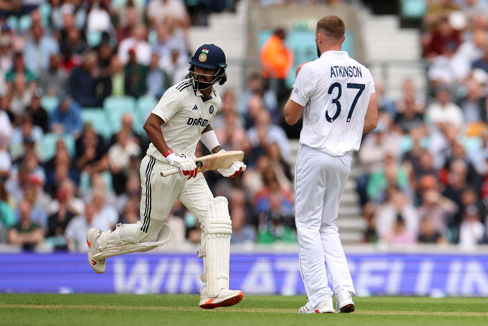India's KL Rahul runs past England's Gus Atkinson on the first day of the fifth Test cricket match between England and India at The Oval in London on July 31, 2025.